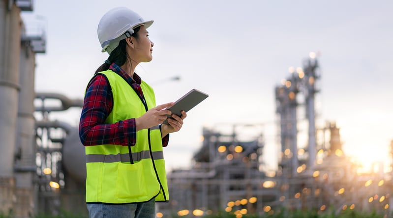 A female energy industry employee working remotely using a tablet