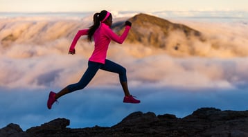 Woman running in front of clouds as metaphor for energy transactions running in the cloud